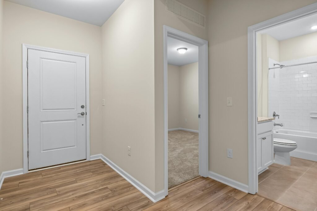 pexels-photo-18041813-18041813 Bright and spacious apartment hallway leading to a bathroom and a room.